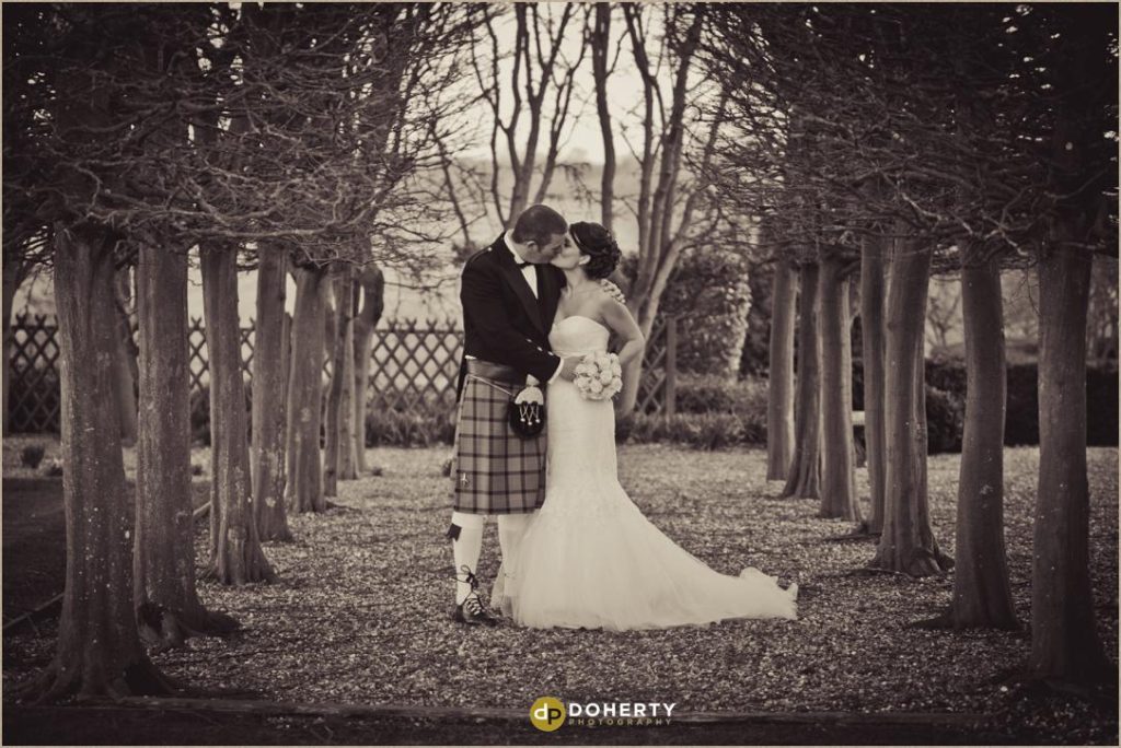 Bride and Groom in Fawsley Hall Tree Lined Garden