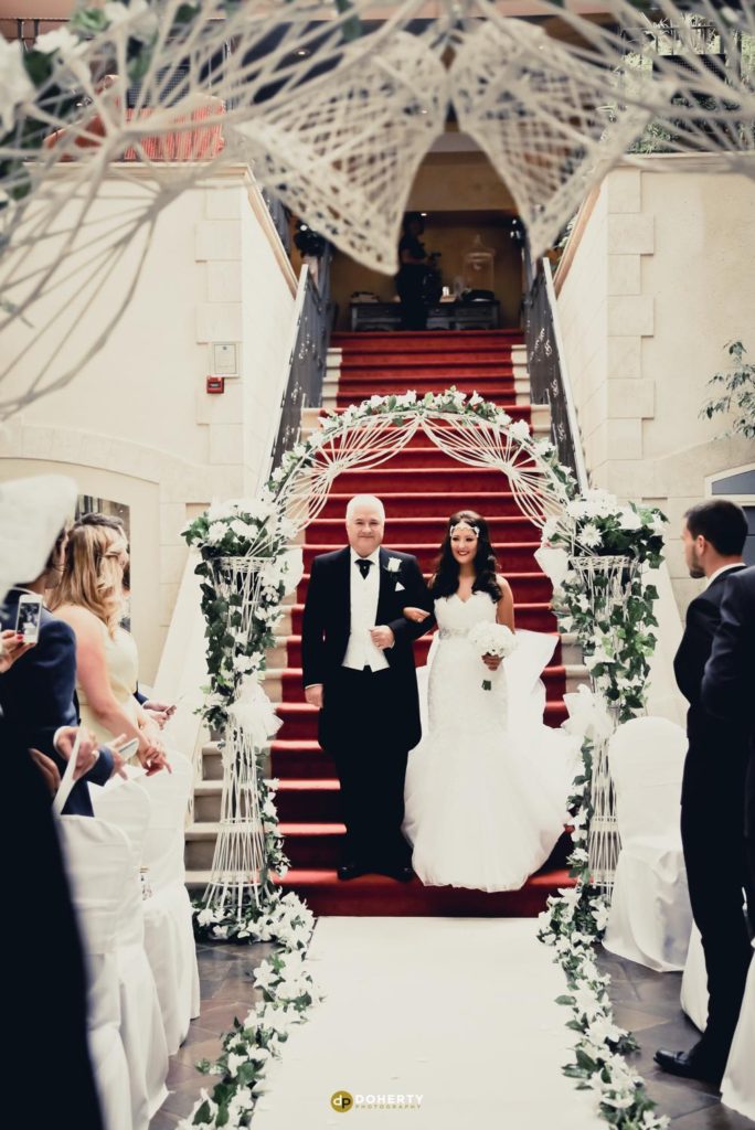 Bride walks down the steps at Nailcote Hall
