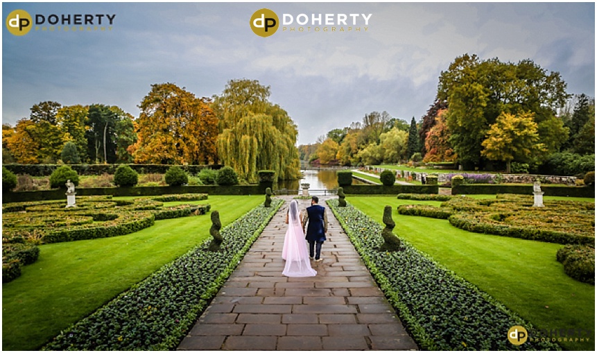 Asian wedding bride and groom in gardens at Coombe Abbey