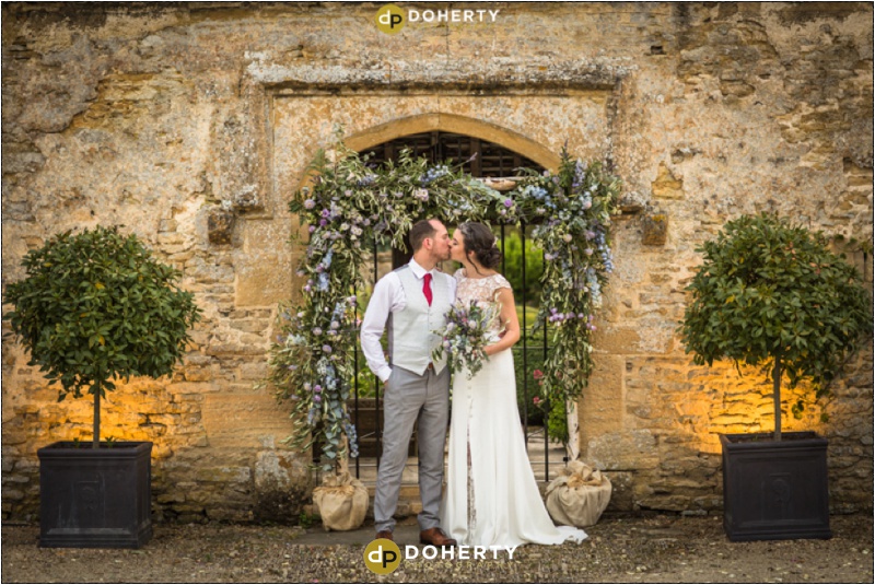Caswell House Wedding Couple in front of Flowers Photo