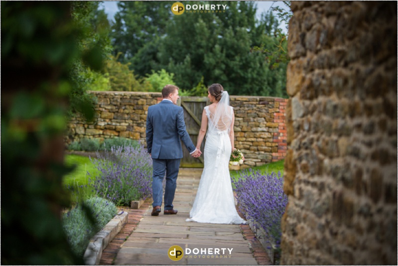 Dodford Manor Bride and Groom walking in gardens