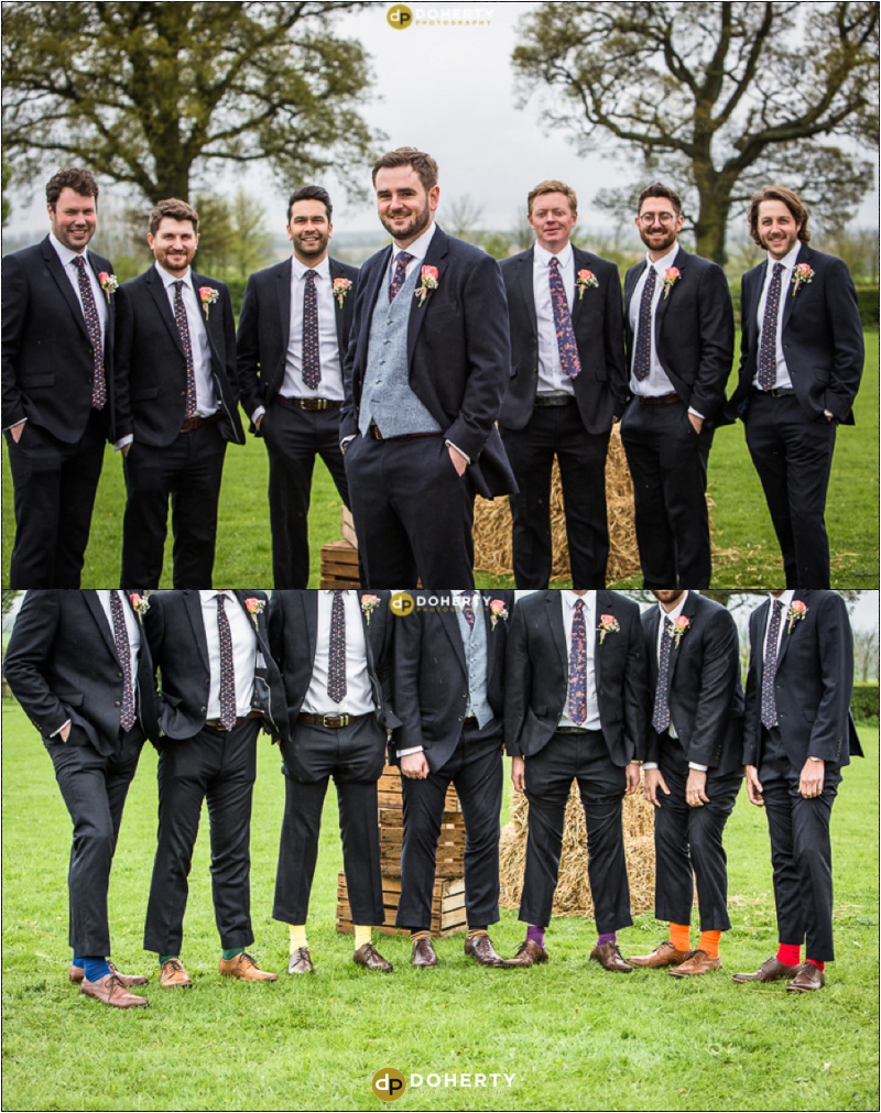 Groomsmen showing off coloured socks