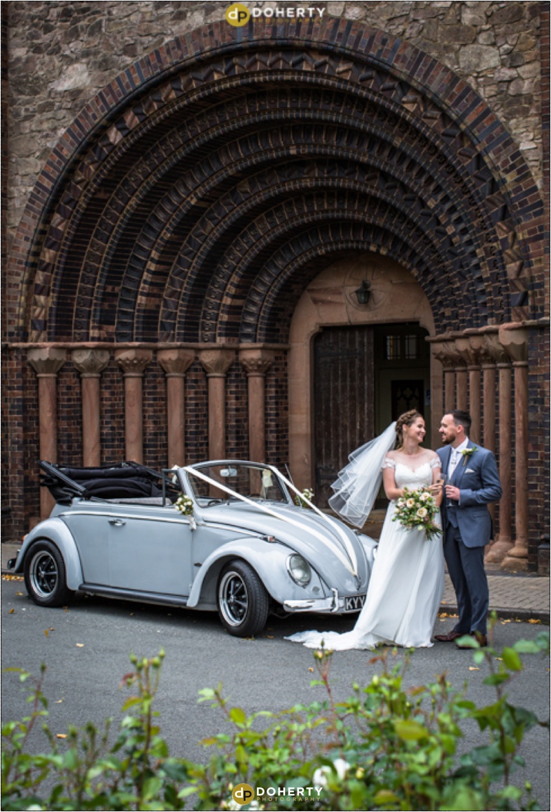 Church wedding couple outside church with car