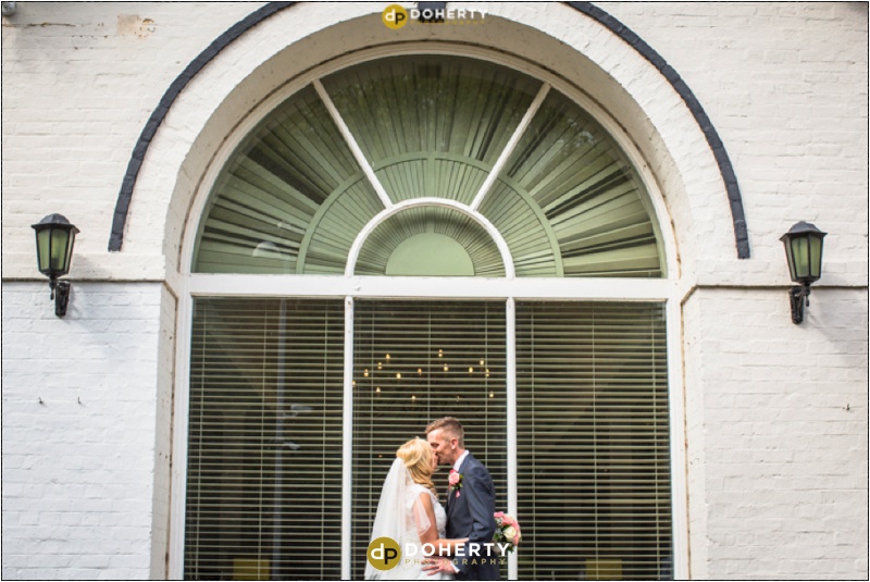 Brandon Hall Wedding Photography of bride and groom in large window