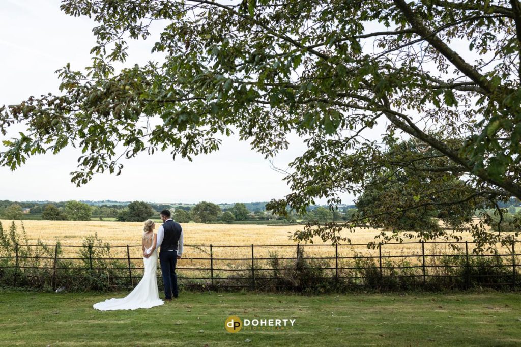 Bride and groom at fields at the Woodlands at Catthorpe Manor