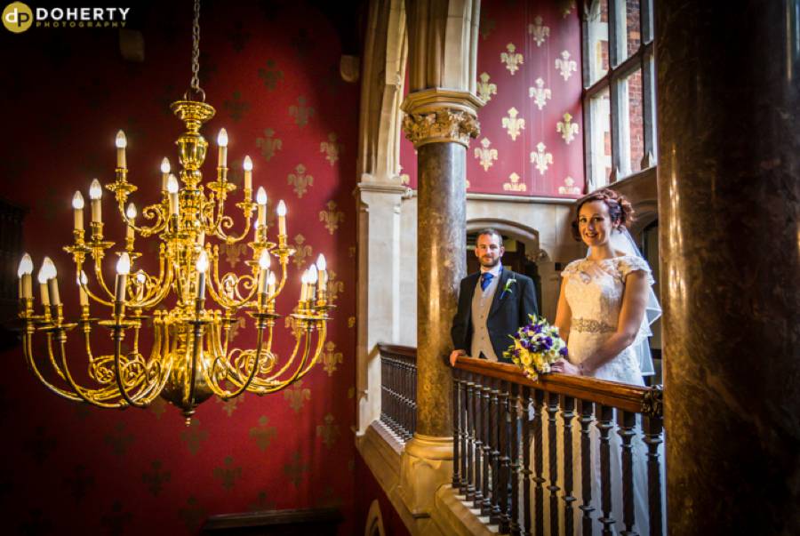 Brownsover hall Bride and Groom by Chandelier