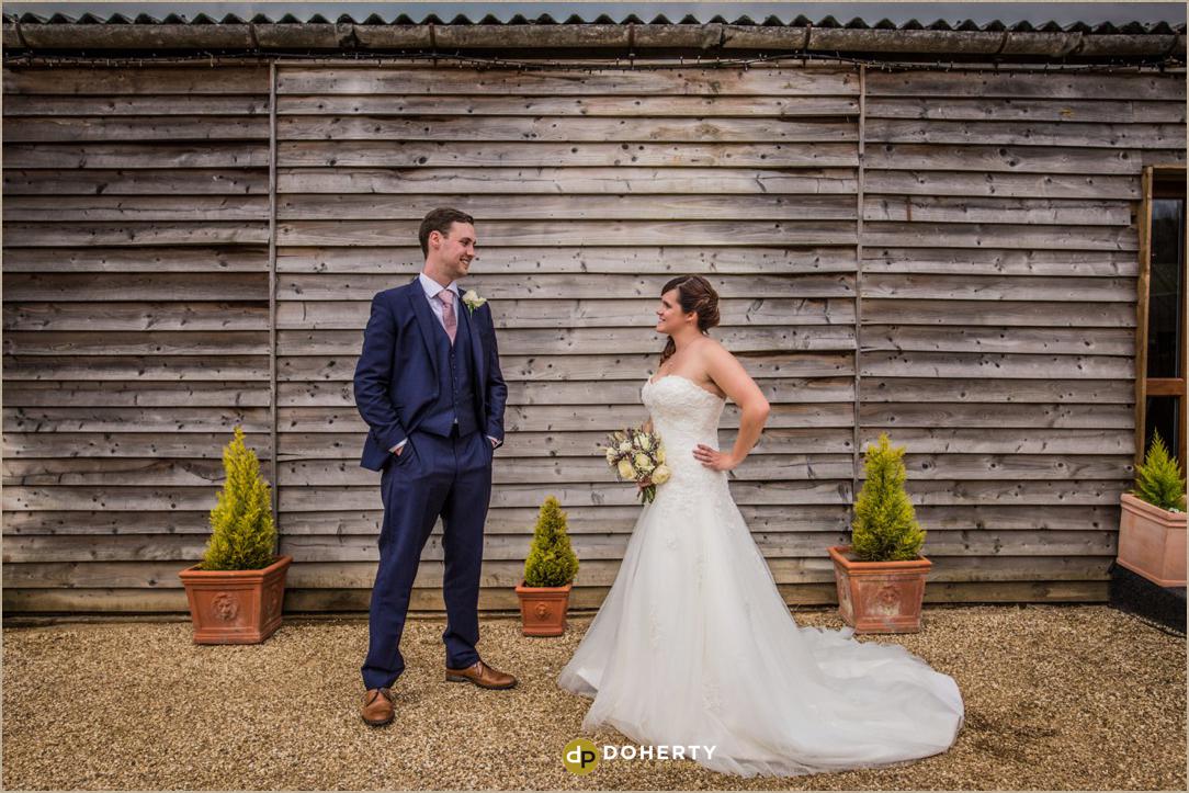 The Granary at Fawsley bride and groom outside barn