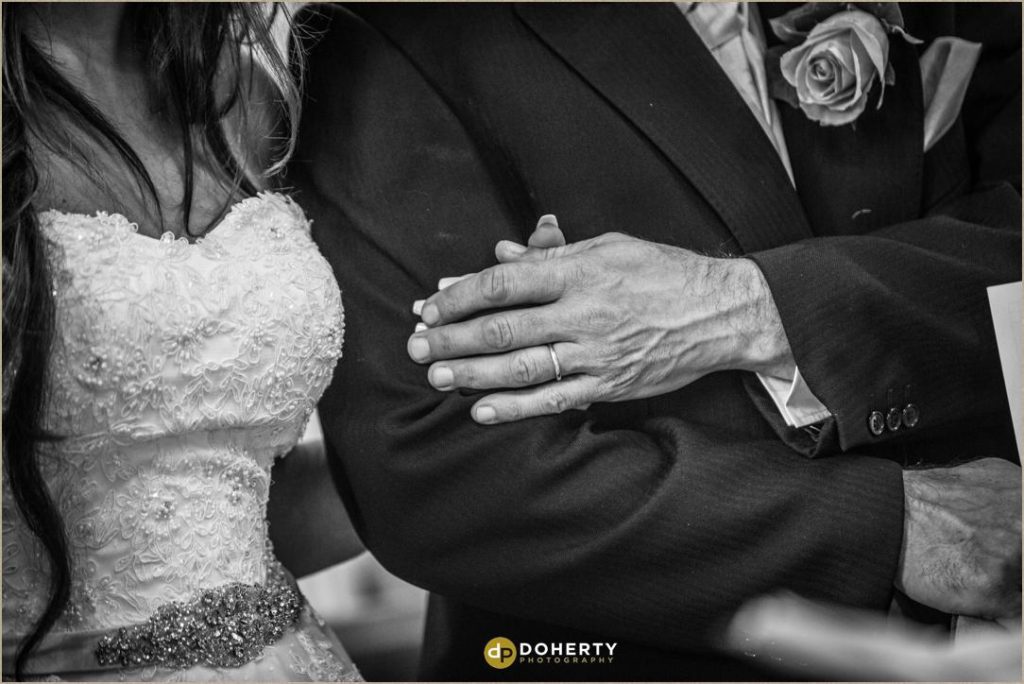 Father holds bride hand