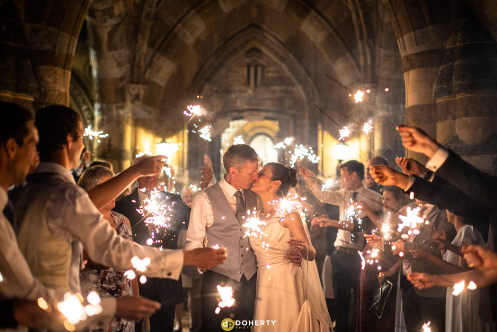 Sparkler photo with bride and groom at wedding