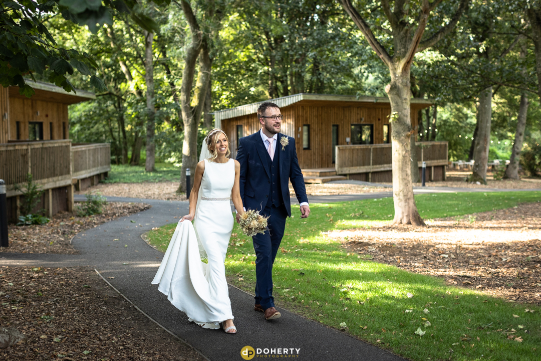 Bride and Groom walking at the Woodlands at Hothorpe Hall