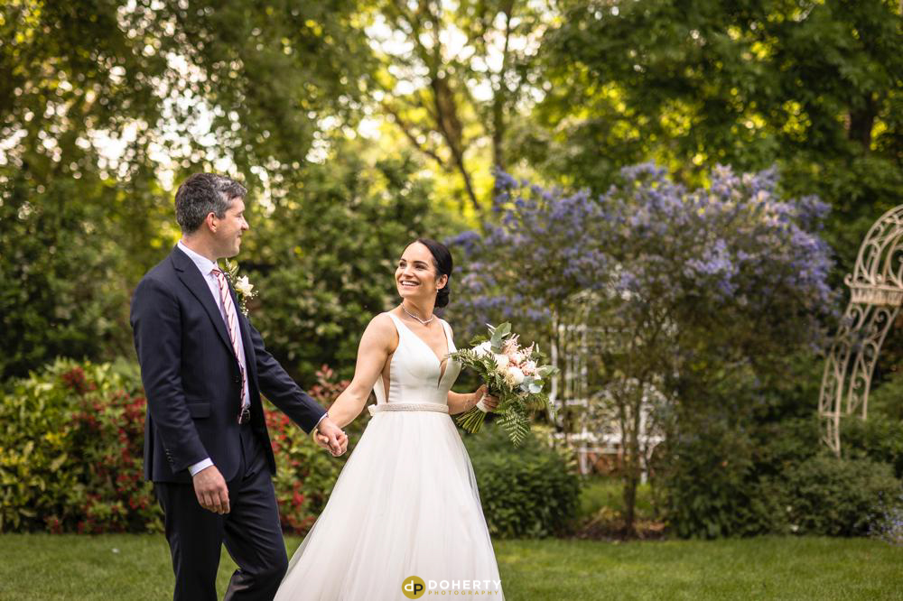 Summer Wedding - Warwick House Photographer with bride and groom walking in gardens