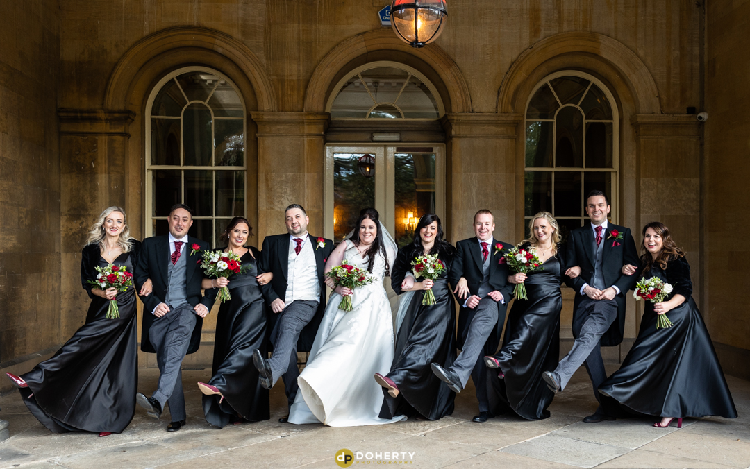 Bridal party dancing outside Prestwold Hall