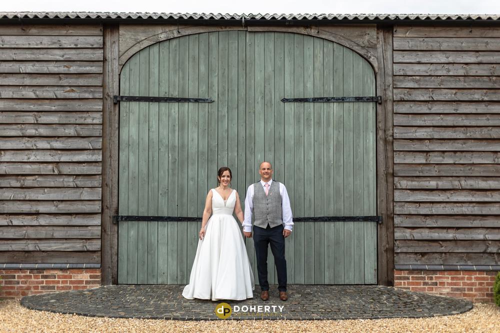 Primrose Hill farm with bride and groom at barn doors