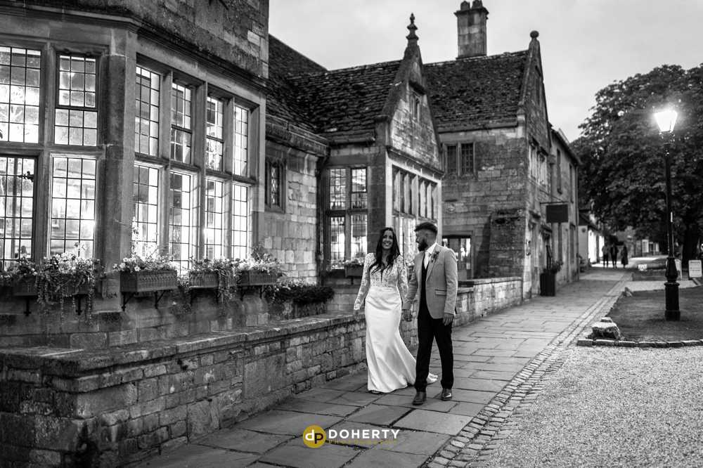 Lygon Arms Hotel with bride and groom walking outside