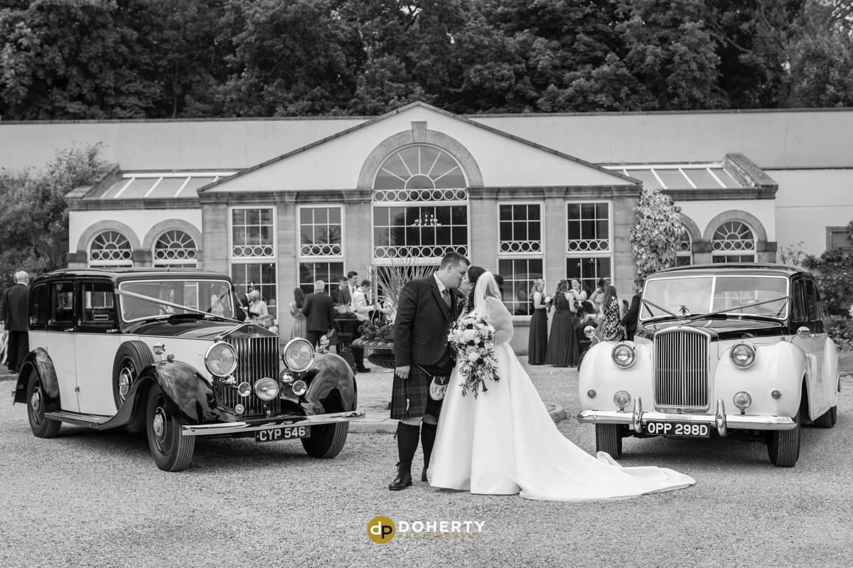 Whittlebury Hall with wedding cars outside orangery