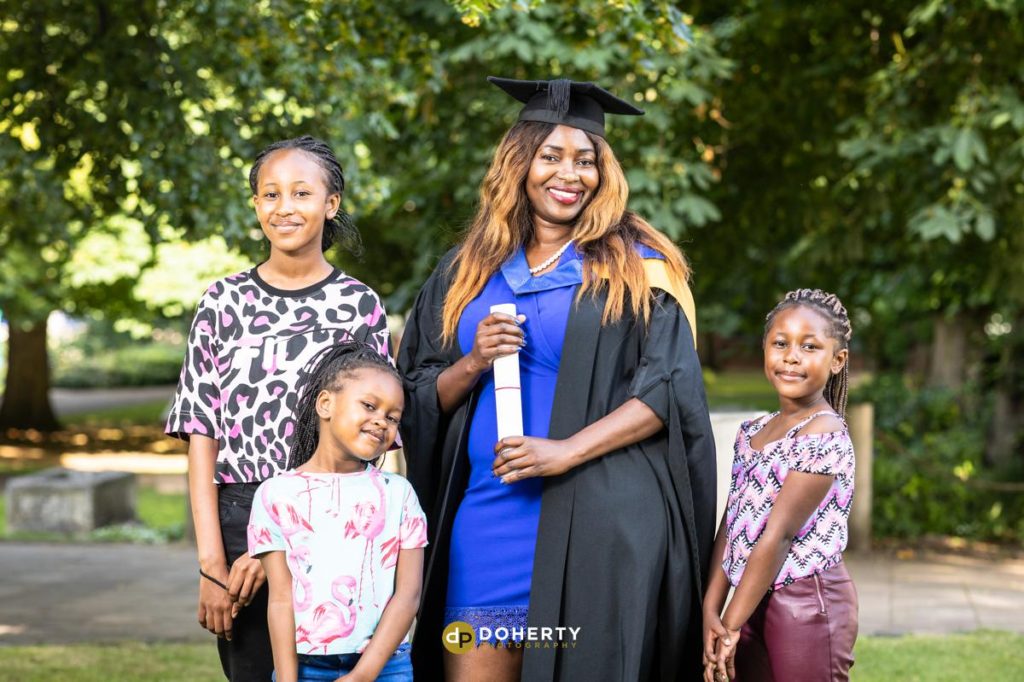 Graduation photo of young woman with children at Coventry University