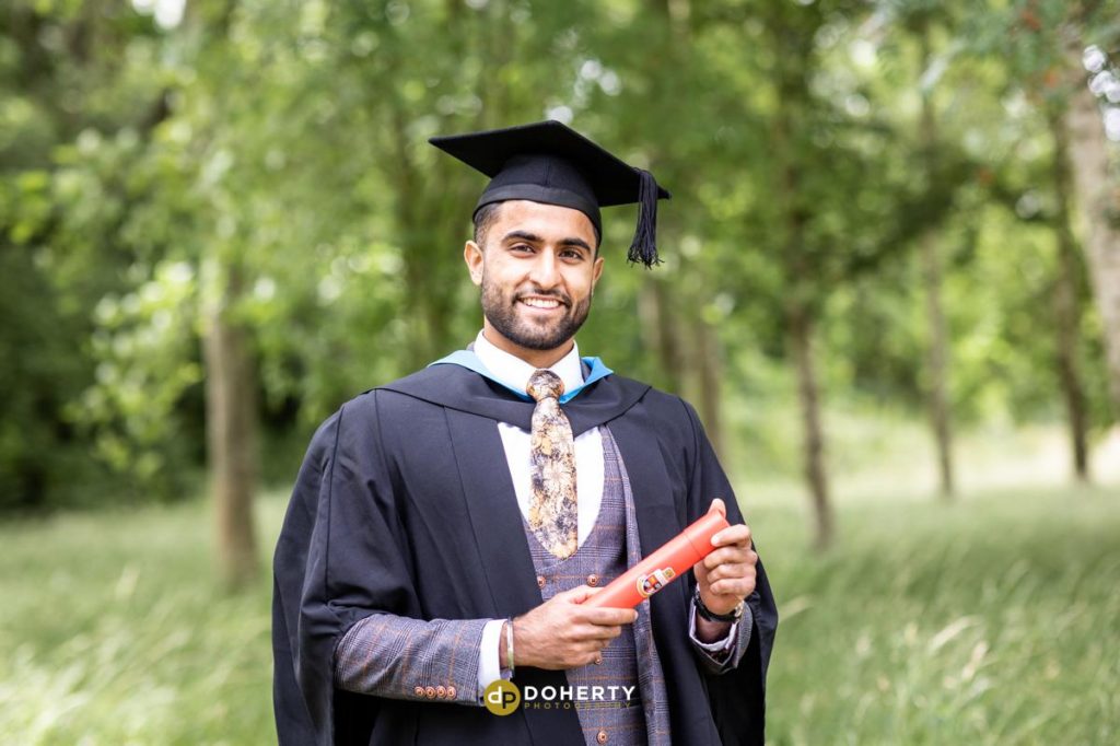 Graduation portrait on fields at Warwick University