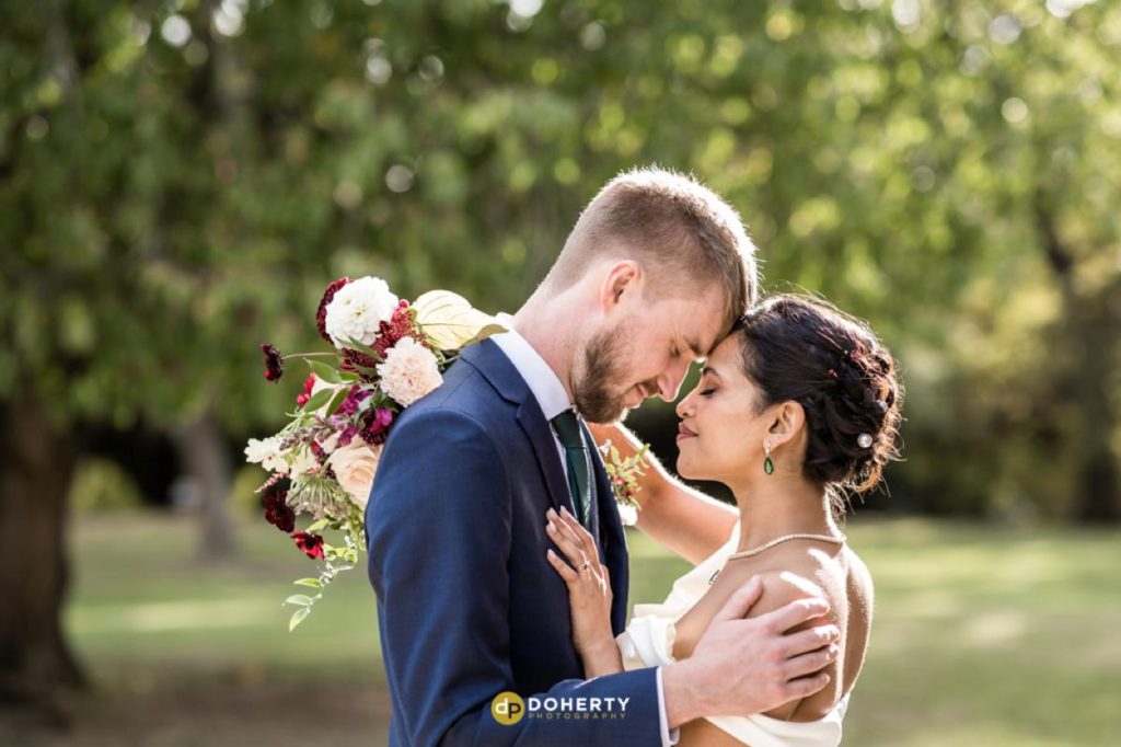 Bride and groom embrace at Eastington park