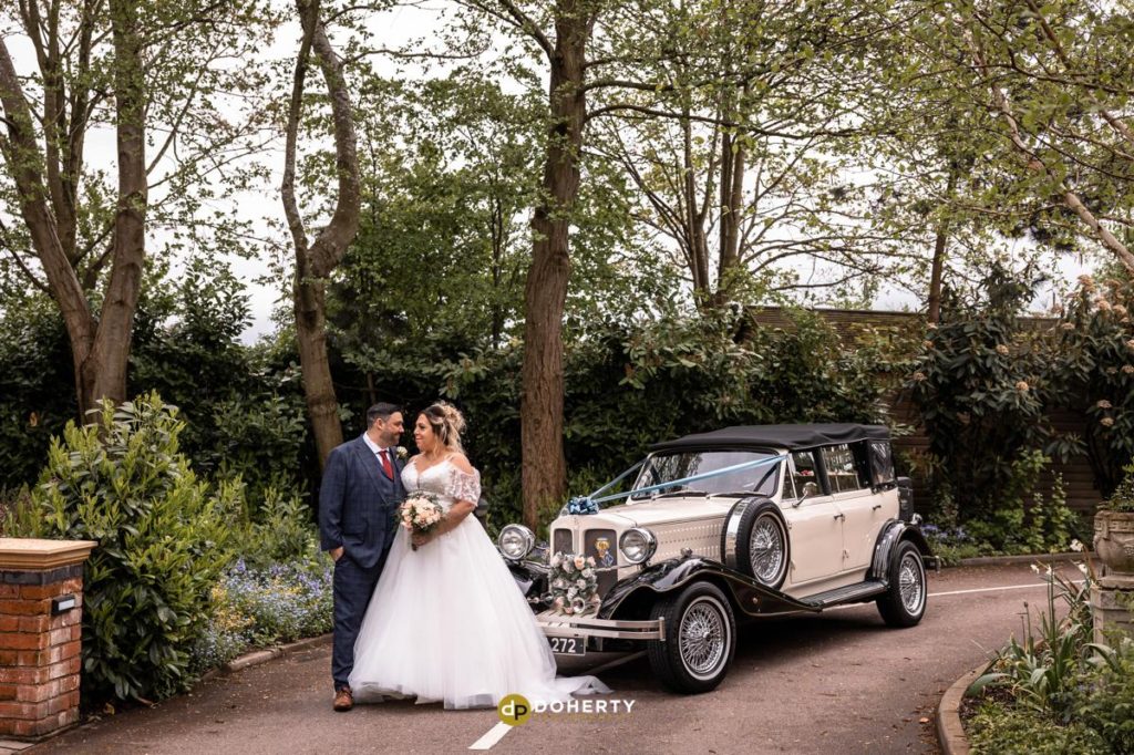 Bride and groom with wedding car at Fairlawns Hotel in Walsall