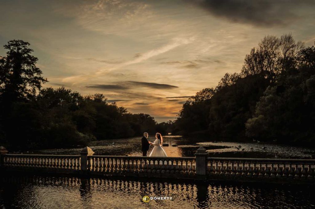 Twilight photo on bridge with bride and groom